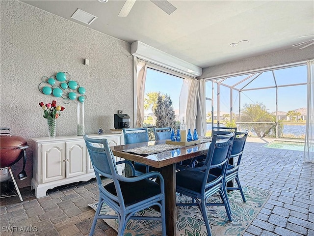 interior space featuring ceiling fan and a water view