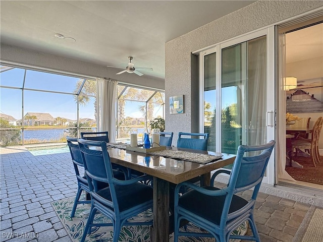 sunroom / solarium featuring ceiling fan