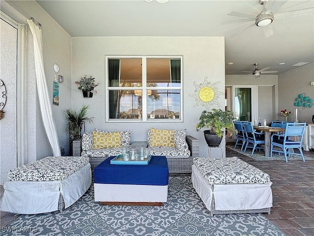 interior space featuring an outdoor hangout area and ceiling fan