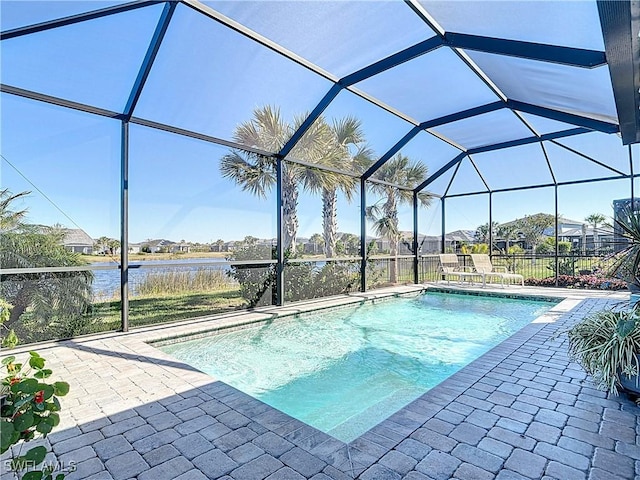 view of swimming pool with a water view, a lanai, and a patio area