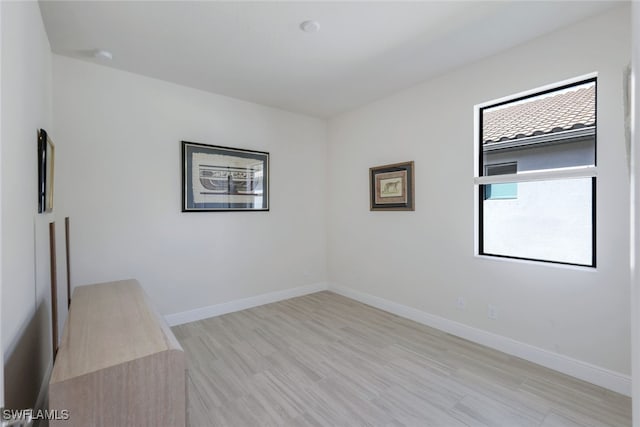 unfurnished room with light wood-type flooring