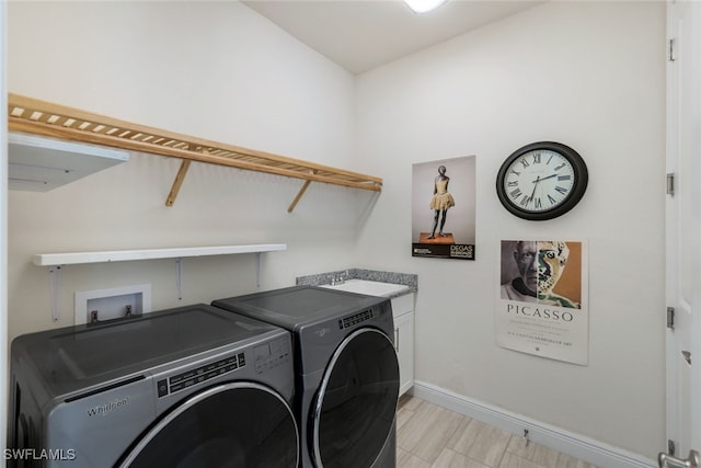 laundry room with independent washer and dryer, sink, and cabinets