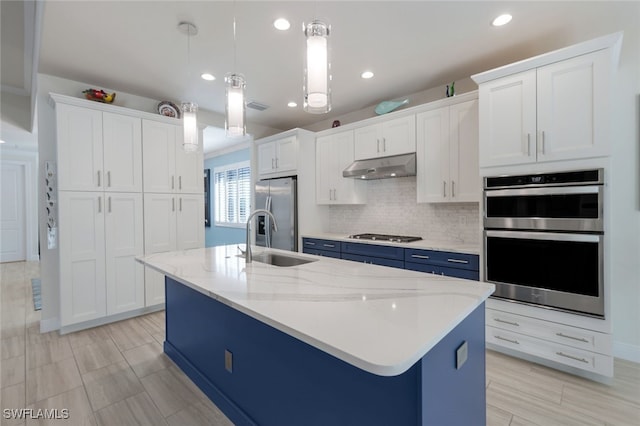 kitchen with decorative light fixtures, white cabinets, and appliances with stainless steel finishes