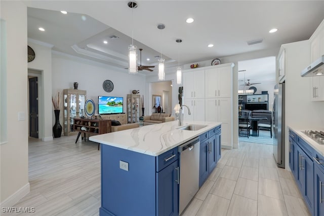 kitchen with blue cabinetry, sink, a center island with sink, stainless steel appliances, and white cabinets