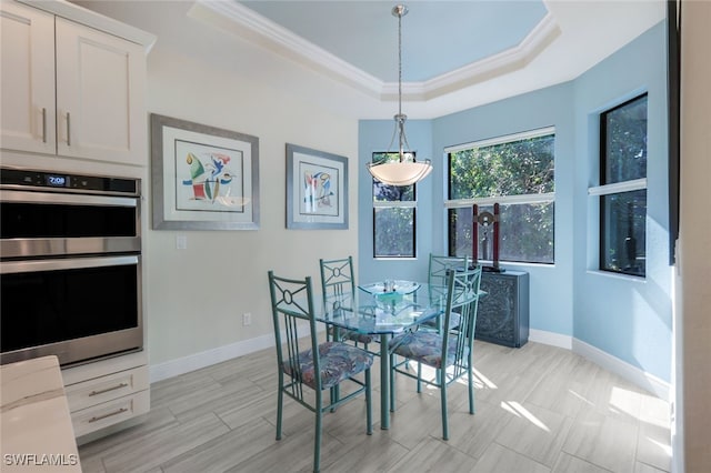 dining area featuring crown molding and a tray ceiling