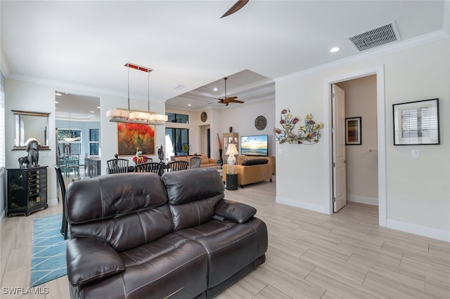 living room featuring ornamental molding, light wood-type flooring, and ceiling fan