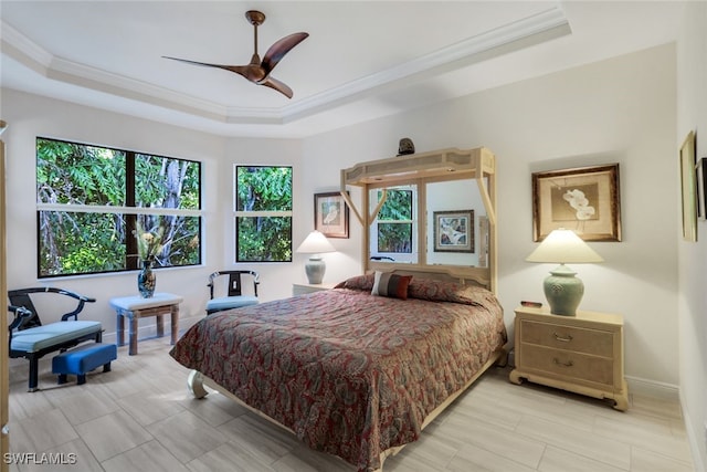 bedroom featuring a raised ceiling, crown molding, and ceiling fan