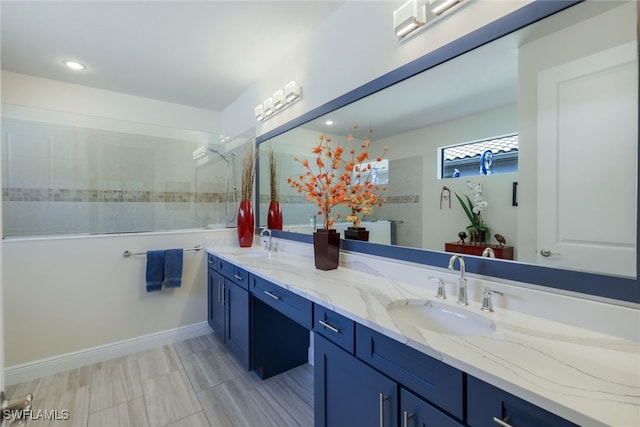 bathroom with vanity and a tile shower