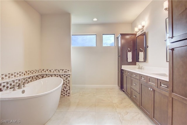 bathroom featuring vanity, a washtub, and tile patterned floors