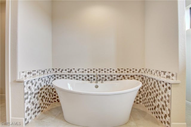 bathroom with tile walls, a bath, and tile patterned floors