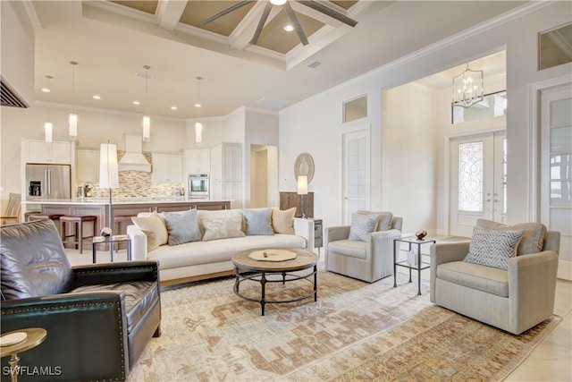 living room with coffered ceiling, a towering ceiling, and crown molding