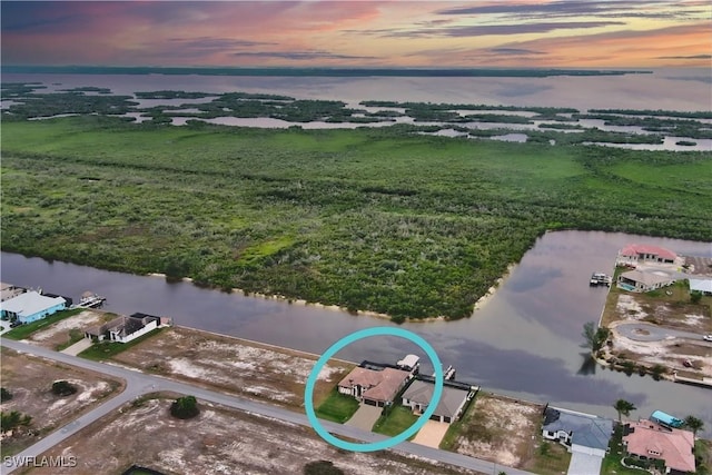 aerial view at dusk with a water view