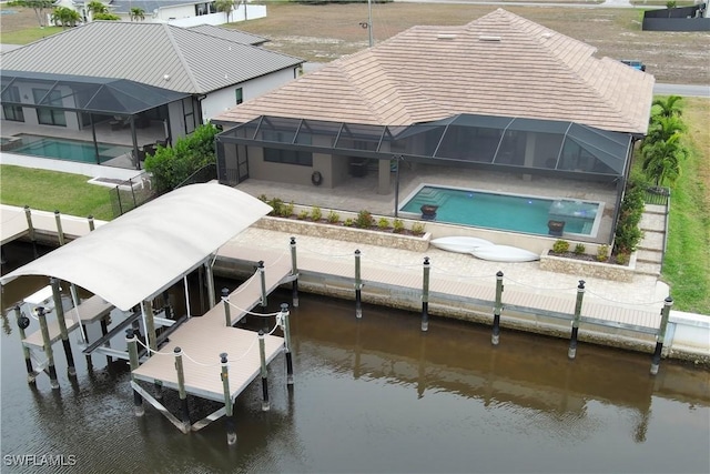 exterior space with a lanai, a patio, and a water view