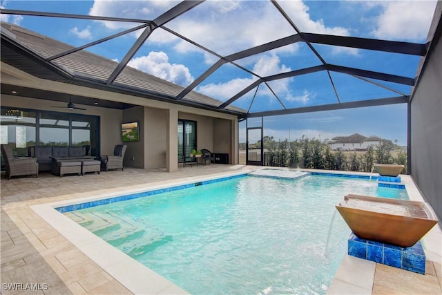 view of swimming pool featuring ceiling fan, a patio, glass enclosure, an outdoor hangout area, and pool water feature