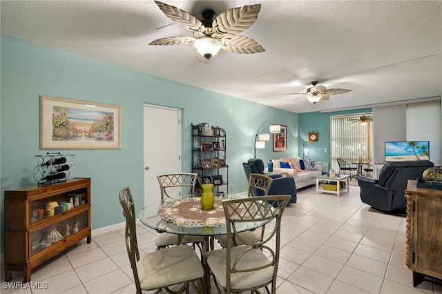 dining room with light tile patterned floors, a textured ceiling, and ceiling fan