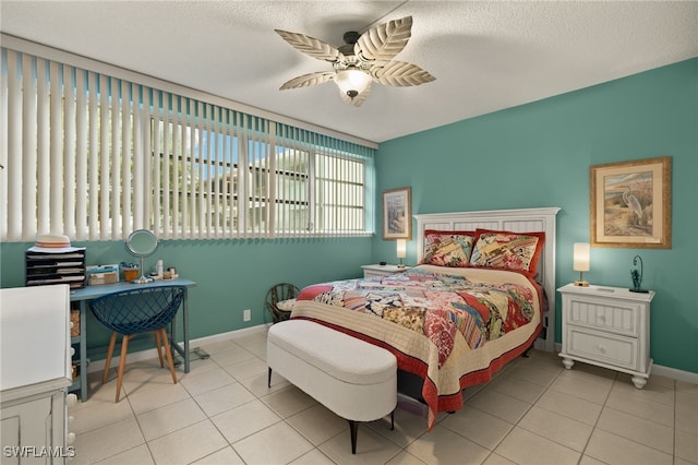 bedroom featuring ceiling fan, a textured ceiling, and light tile patterned floors