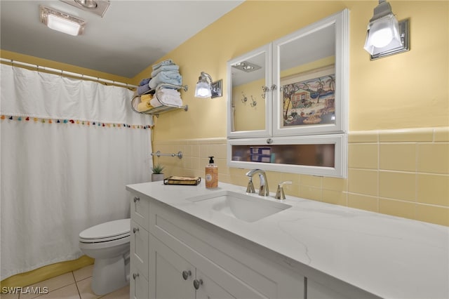 bathroom with tile patterned flooring, vanity, and toilet