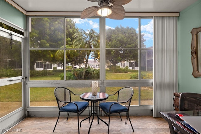 sunroom featuring ceiling fan