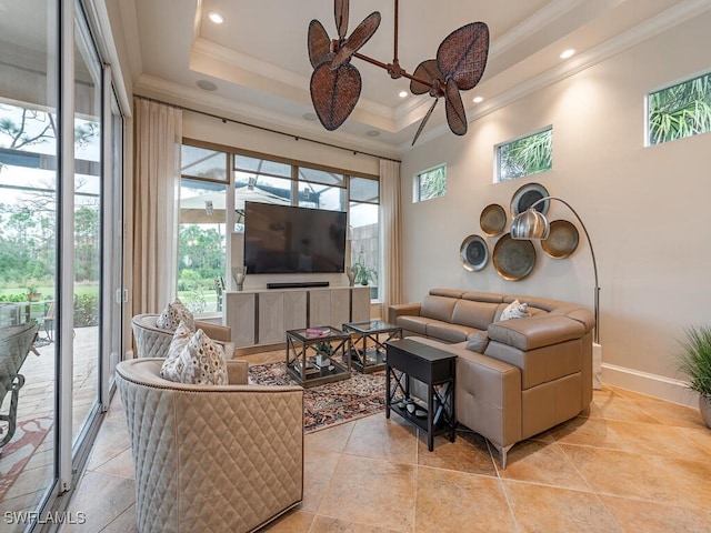 living room featuring crown molding, a raised ceiling, and a high ceiling