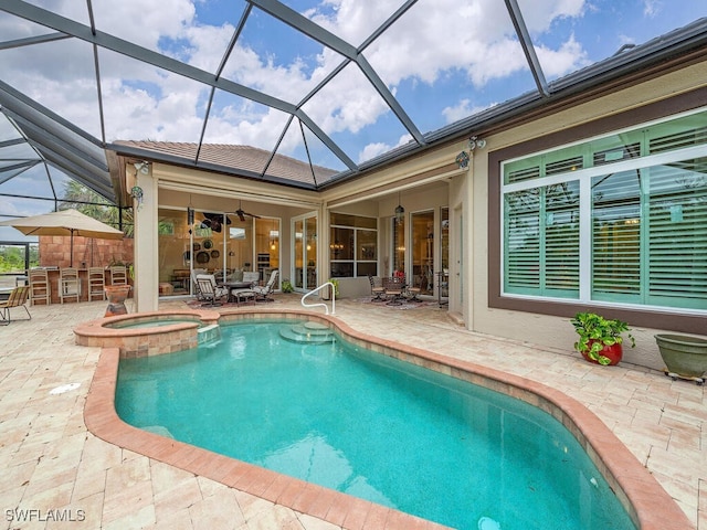 view of swimming pool with a bar, ceiling fan, an in ground hot tub, and a patio