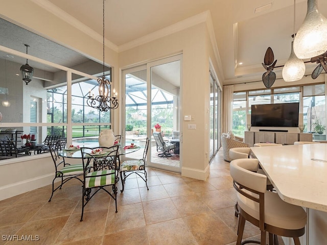 dining room with a notable chandelier, plenty of natural light, and ornamental molding