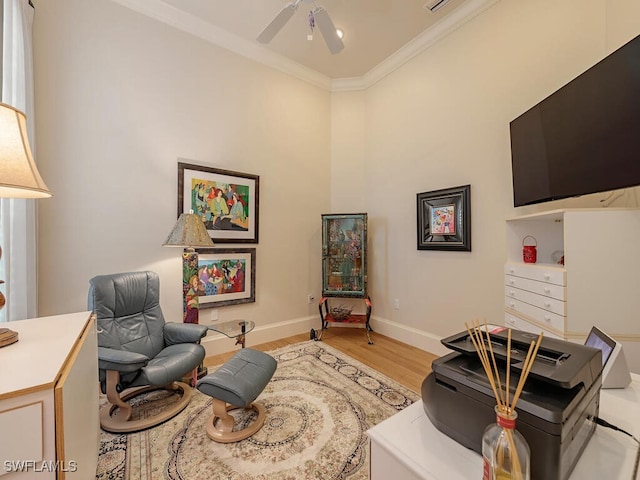 sitting room with ornamental molding, ceiling fan, and light hardwood / wood-style flooring