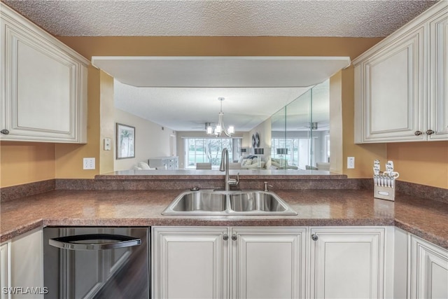 kitchen with open floor plan, dark countertops, a sink, and dishwasher