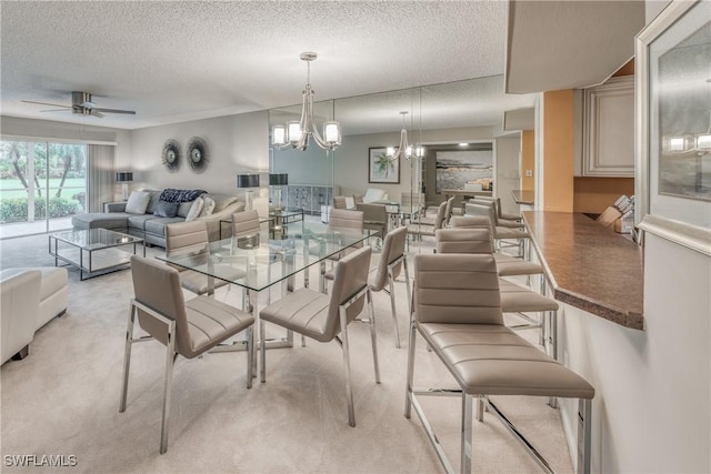 dining area featuring light colored carpet, a textured ceiling, and ceiling fan with notable chandelier