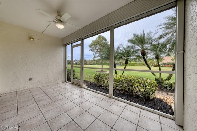 unfurnished sunroom featuring a ceiling fan