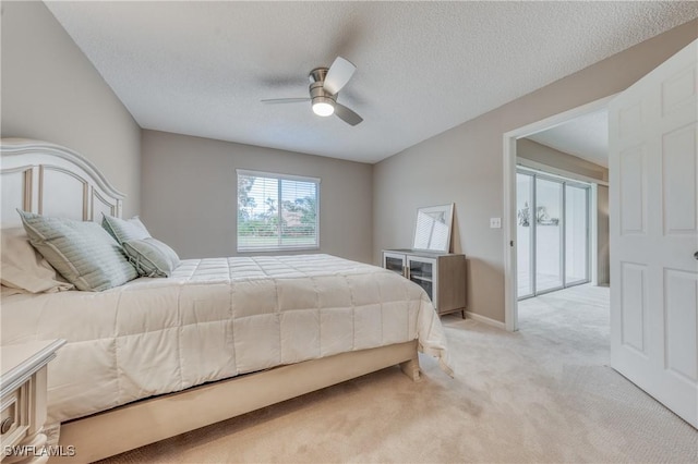 bedroom with a textured ceiling, ceiling fan, baseboards, and light colored carpet