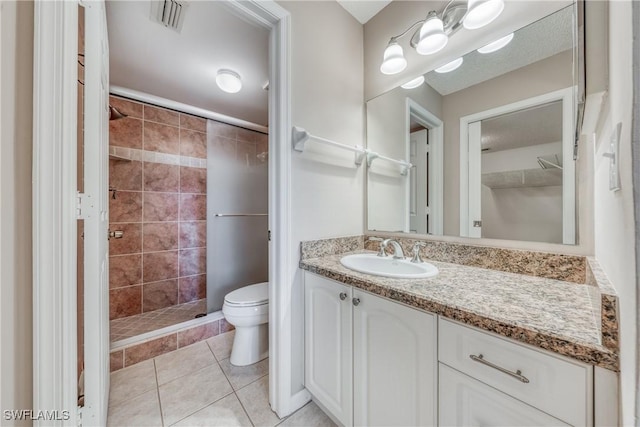 full bathroom with tile patterned flooring, toilet, visible vents, vanity, and a shower stall