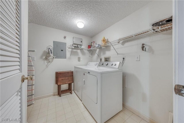 clothes washing area with a textured ceiling, laundry area, baseboards, washer and dryer, and electric panel