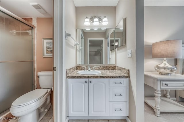 full bath with visible vents, a stall shower, vanity, and toilet