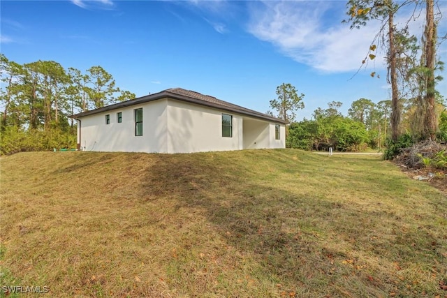 view of side of property featuring a yard