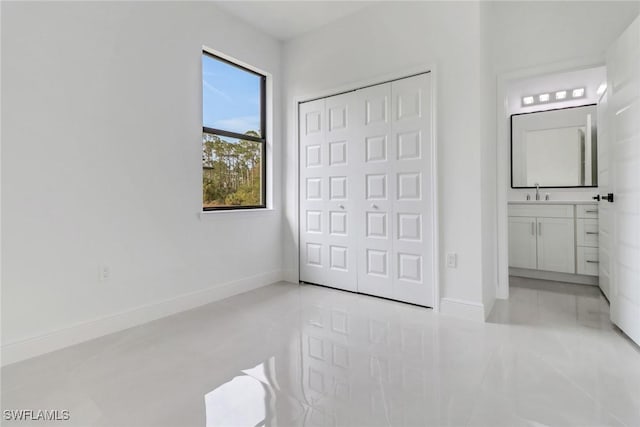 bedroom featuring ensuite bath and light tile patterned floors