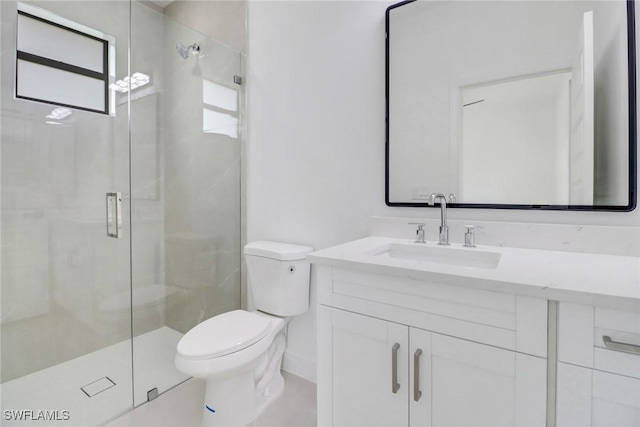 bathroom with vanity, toilet, and a shower with shower door