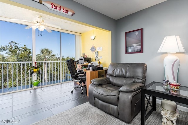 tiled living room featuring ceiling fan and a wealth of natural light