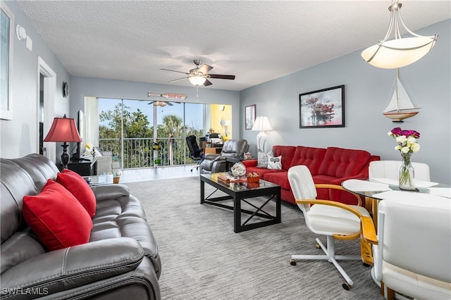 carpeted living room featuring ceiling fan and a textured ceiling