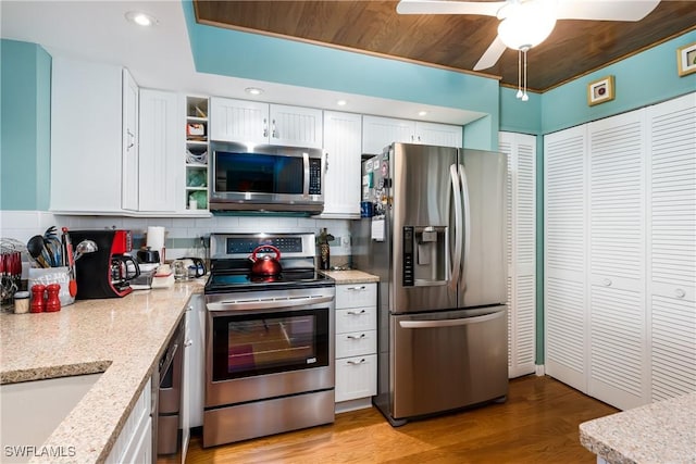 kitchen with white cabinetry, decorative backsplash, and appliances with stainless steel finishes