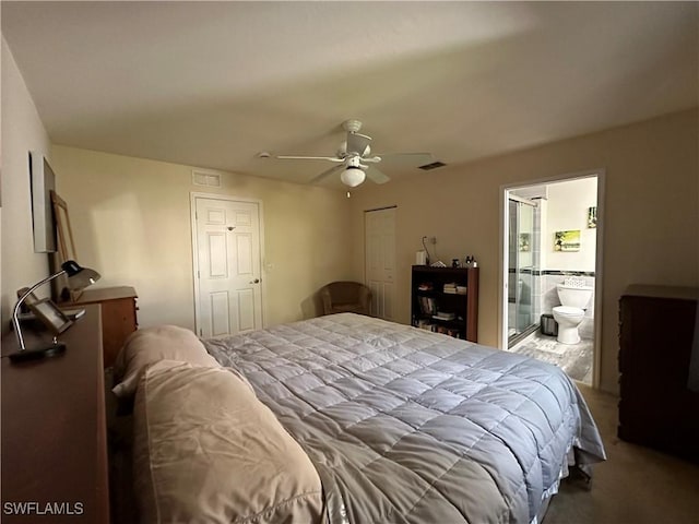 bedroom featuring connected bathroom, light colored carpet, ceiling fan, and a closet