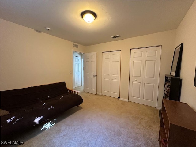 living area featuring light carpet