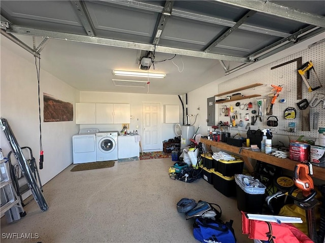 garage with a garage door opener, washing machine and dryer, and a workshop area