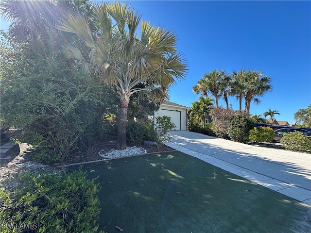 obstructed view of property with a garage