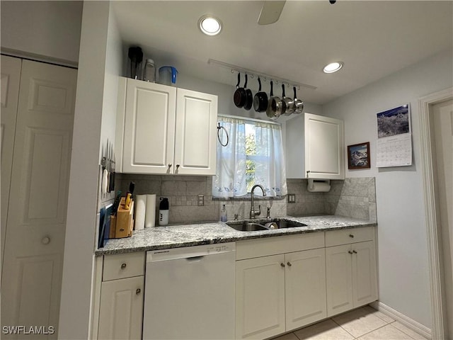 kitchen featuring sink, dishwasher, light stone counters, tasteful backsplash, and white cabinets