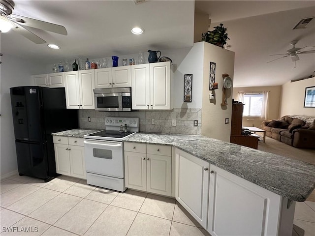 kitchen with black refrigerator, white cabinetry, white electric range oven, and kitchen peninsula