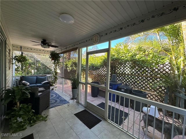 sunroom / solarium featuring ceiling fan