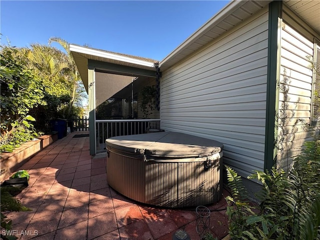 view of patio / terrace featuring a hot tub and central AC