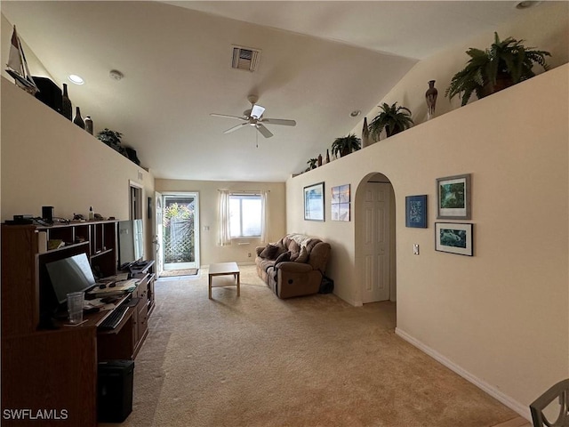 carpeted living room with ceiling fan and lofted ceiling