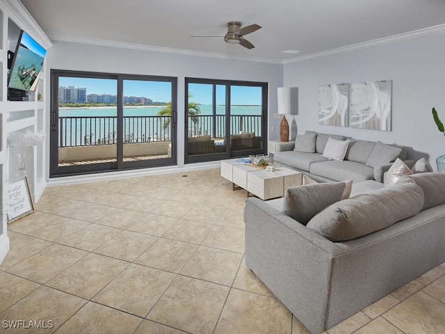 tiled living room with crown molding, ceiling fan, and a water view