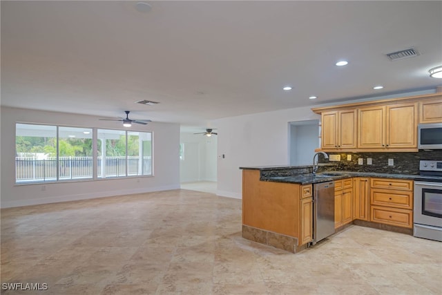 kitchen featuring stainless steel appliances, visible vents, open floor plan, dark stone counters, and a peninsula